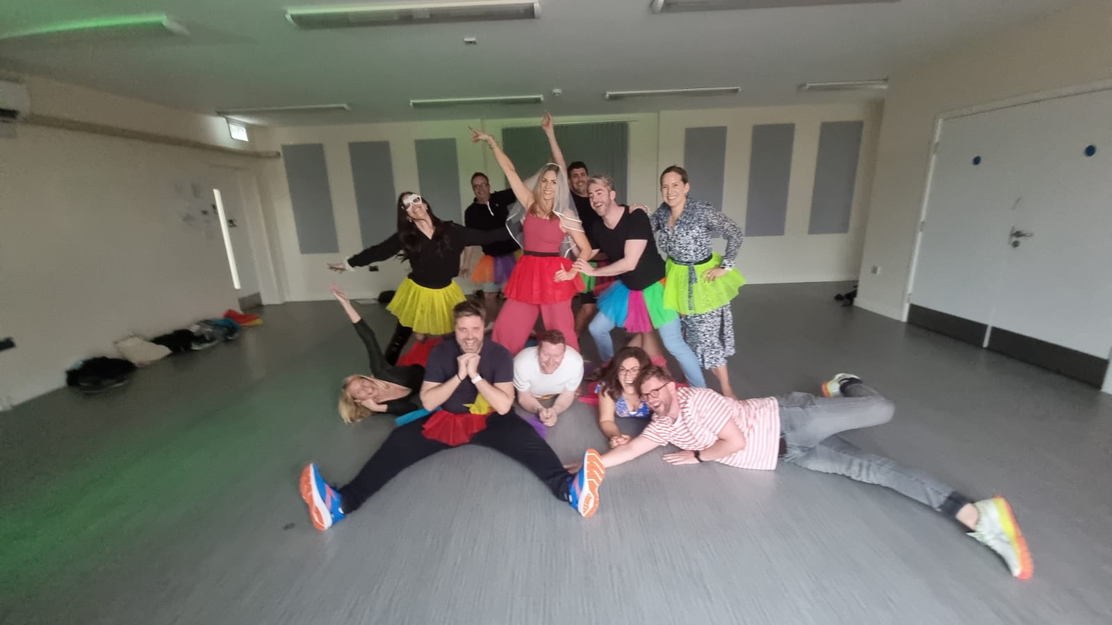 Group enjoying Barbie dance hen party with pink tutus and girl power moves