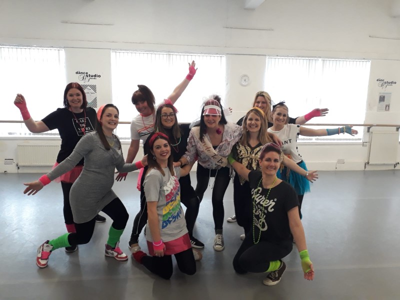 Group enjoying Mamma Mia dance hen party with ABBA moves and musical choreography